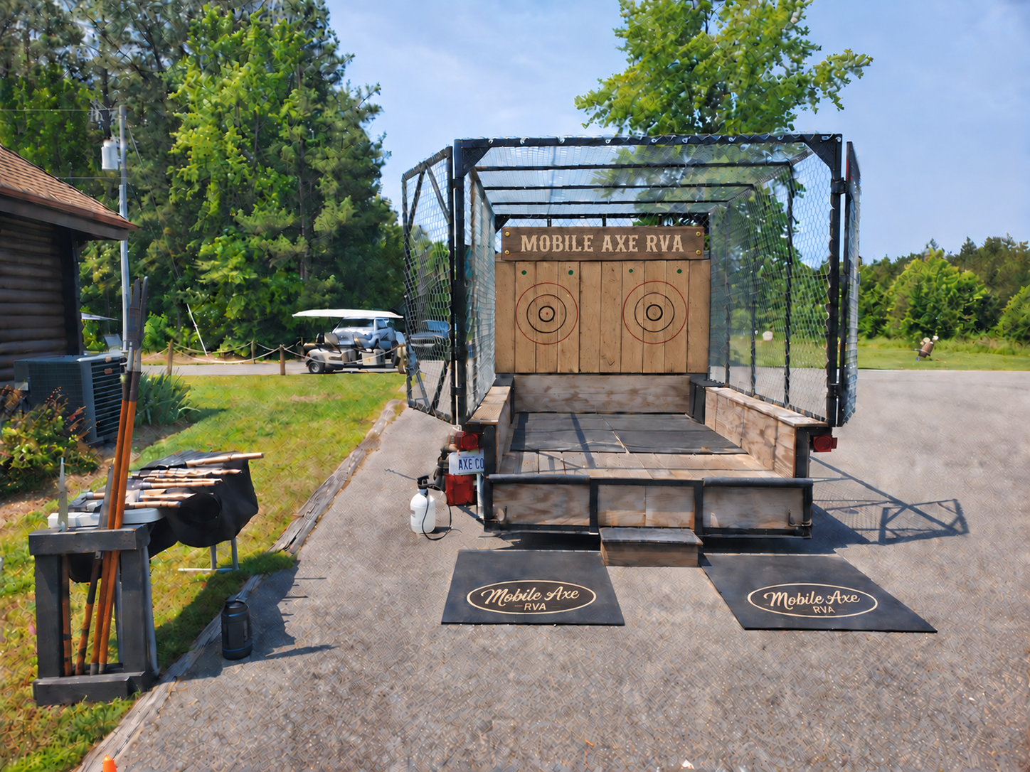 Front-on view into the cage trailer, showing both wooden targets and throwing area