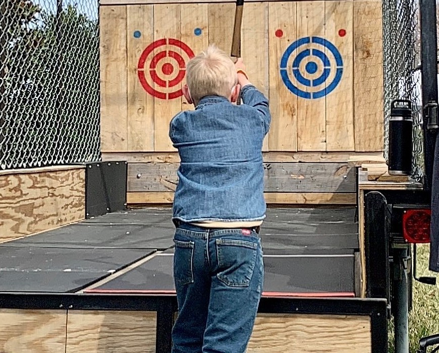A student lining up a throw at the red and blue bullseye boards
