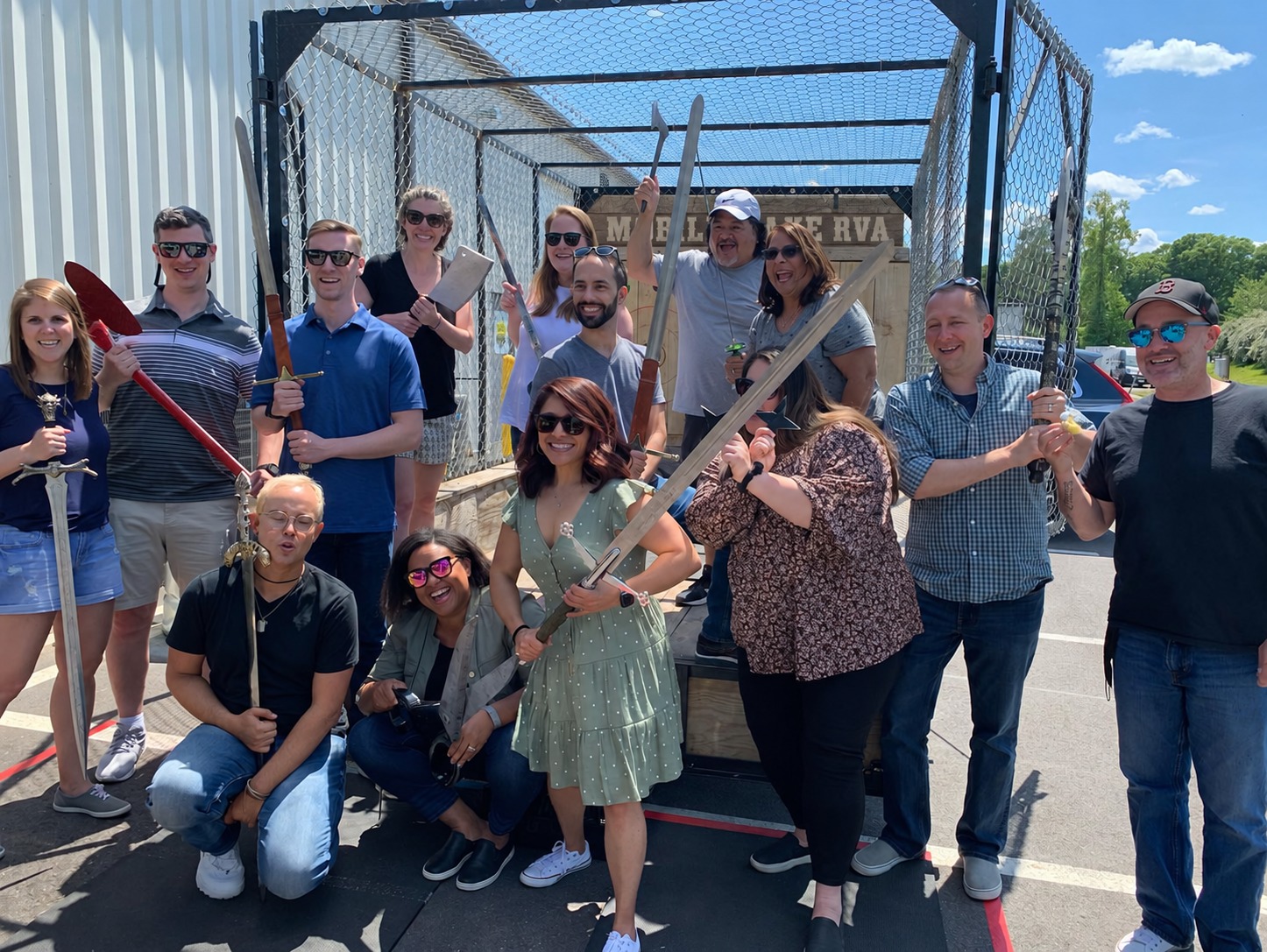 Friends celebrating together beside the mobile axe range
