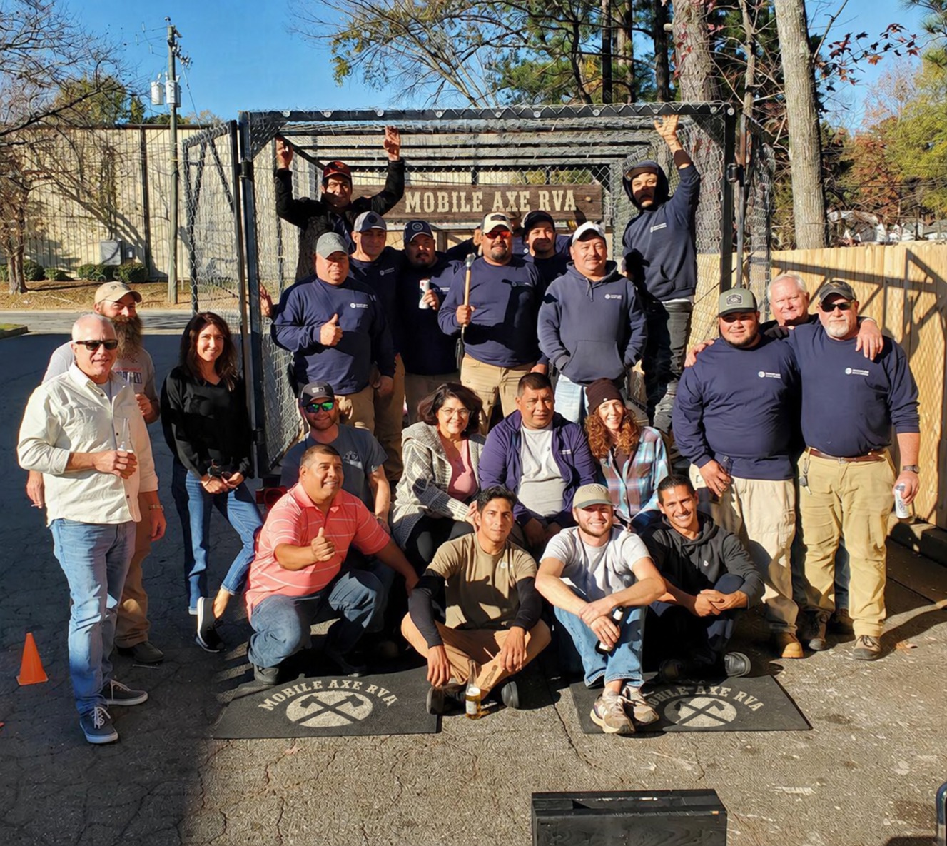 A smiling group gathered around the mobile range outdoors