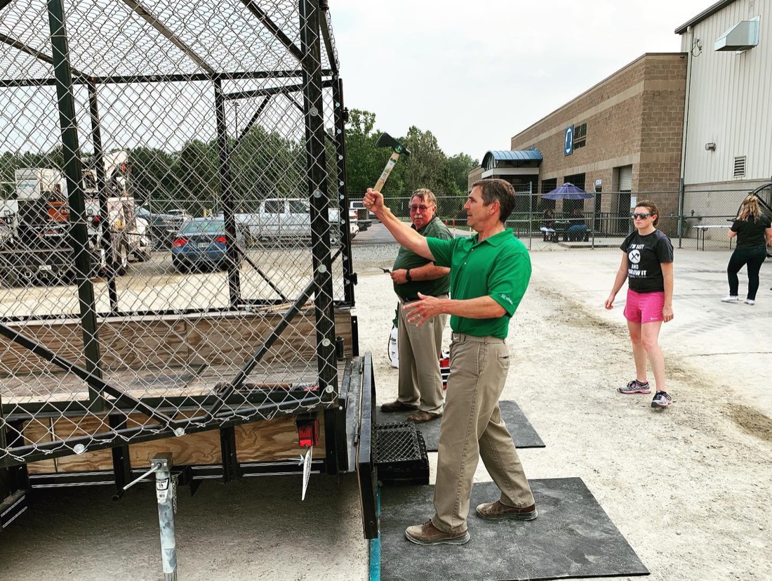 A guest mid-throw at a Mobile Axe RVA corporate event while coworkers watch