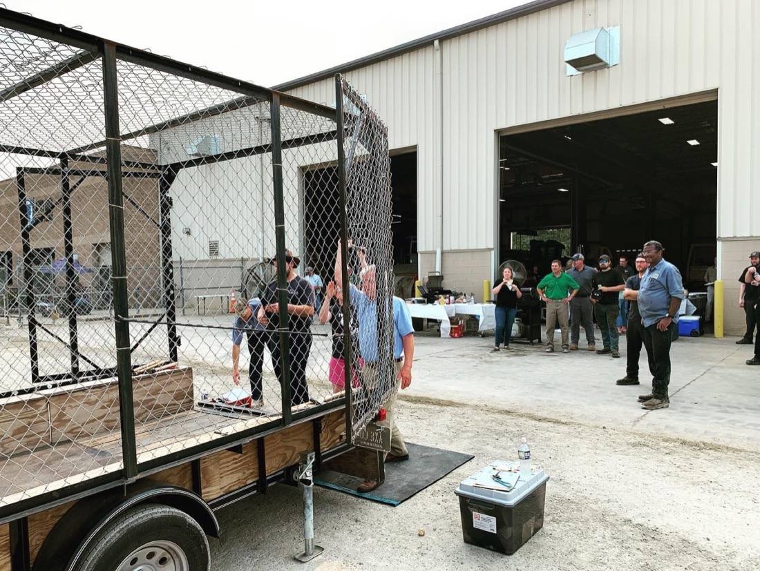 A Mobile Axe RVA coach briefing an employee group at the cage gate